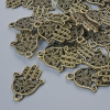 Colgante 'Hamsa', diámetro 21 × 15 mm, diámetro del agujero 1,7 mm, empaque 24 uds ±, color bronce