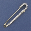 Broche-pasador con strass blancos de 75×16 mm ± metal dorado