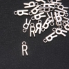 Herrajes para colgante Letra 'R' 17×7 mm, envasado 20 g (+ - 25 uds.)