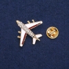 Broche «Avión» 27×30 mm, franja marrón, color dorado del metal