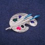 Broche Paleta esmaltada, metal plateado 26×50 mm